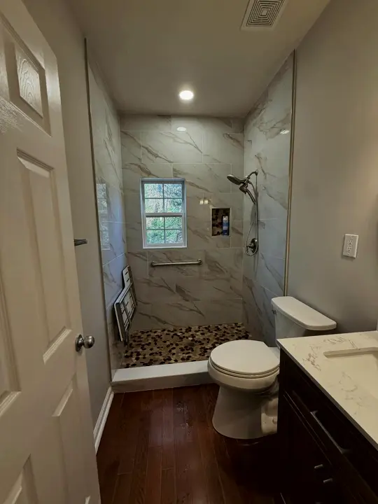 Accessible walk-in shower with grab bars and a fold-down seat
