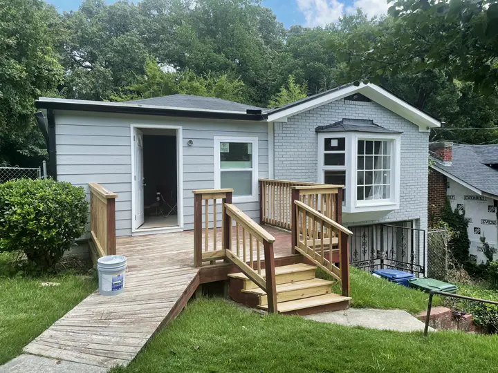 New back deck, steps and access ramp on a grey house