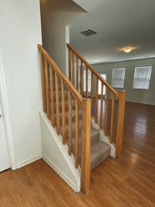 Illustration of the staircase before: a dated oak handrail and plain balusters